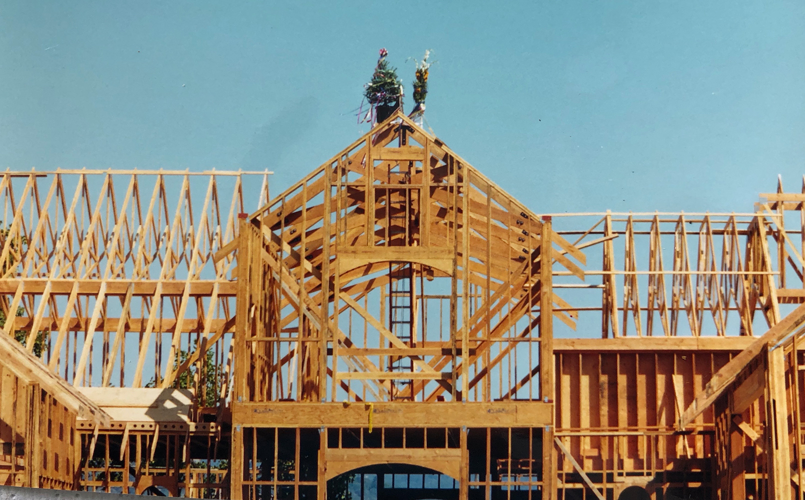 Winery topping off ceremony in 1999. Framed winery with a tree on top.