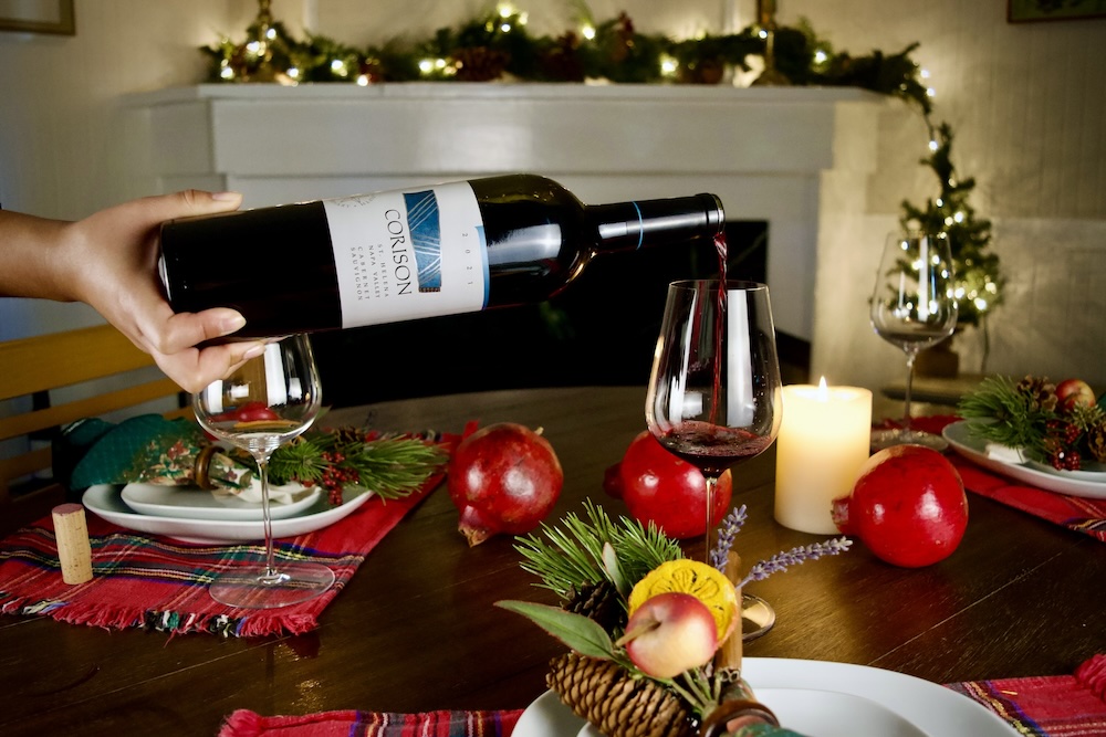 Corison Cabernet being poured into a glass on a festive winter holiday table.